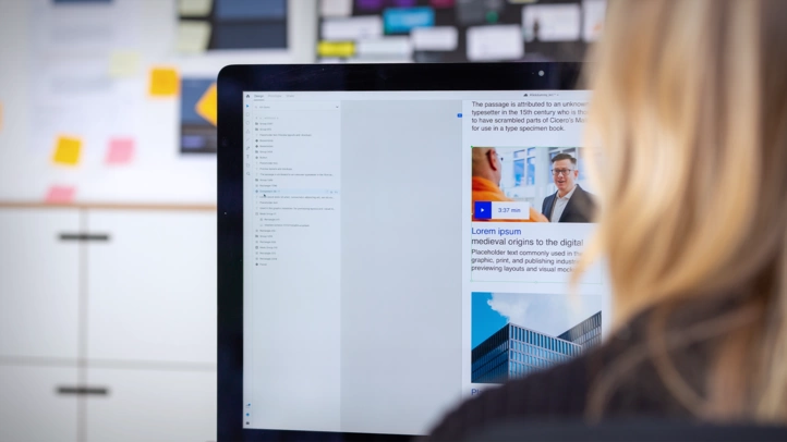 A designer works on an interface design on an iMac.