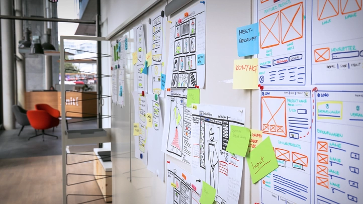 The entrance area of the Lab in the Berlin location. Mobile media walls display hand-painted wireframes and commentary.