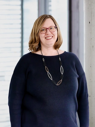 Julia Läkemäker, Chief Operating Officer of ]init[ AG, stands in front of a window in her office in Berlin.