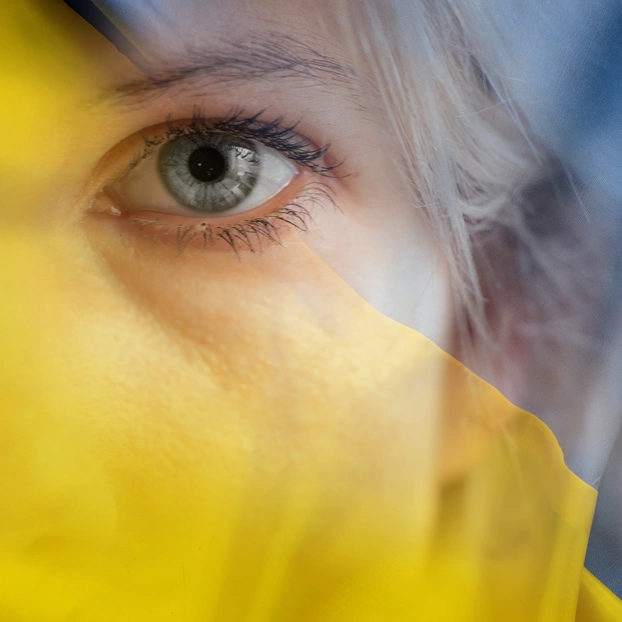 The yellow-blue Ukrainian flag overlaid with the face of a woman.