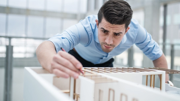 An architect completes a mockup of a building.